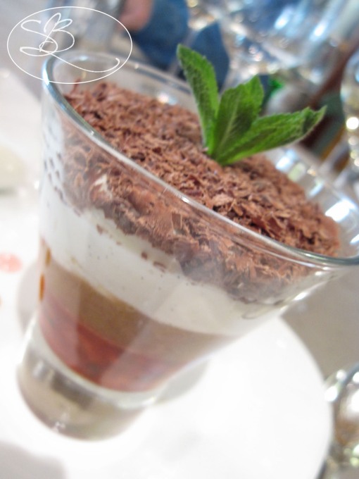 Parfait with layers of chantilly, strawberries, rhubarb, and chocolate shavings
